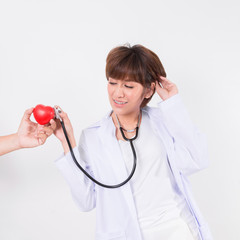 Doctor using stethoscope to exam the  patient heart. Isolated on white background. Studio lighting. Concept for healthy