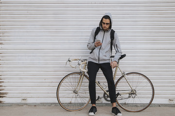 Fototapeta na wymiar young fashioned vintage bike on the street wall