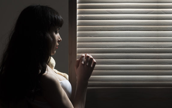 Sexy girl with long dark hair. Light and shadow.