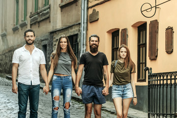 Obraz premium Friends smile on city street, urban style, summer vacation, travel