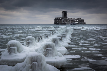 Frozen Baltic sea and ruins old military building in Babie Doly, Gdynia, Poland