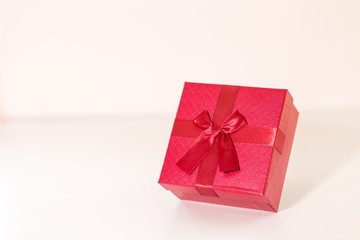 Red gift box on wooden plank. Concept for valentine day.