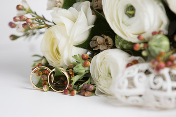 Beautiful wedding bouquet of white roses and rings