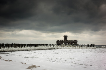 Frozen Baltic sea and ruins old military building in Babie Doly, Gdynia, Poland
