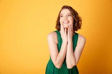 portrait of young happy woman isolated on orange