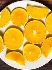 Slices of orange on wood background. top view
