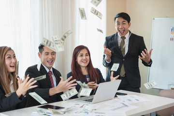 Asian business man and woman groups, successful business. There is a lot of money. with a laptop at office desk and document. business success concept