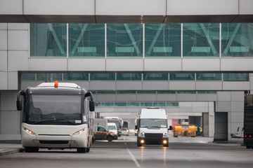 Airfield bus while driving through the airport, front view/Shuttle bus for transportation of...