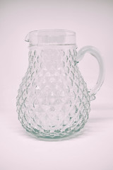 Glass jug of water isolated on white background