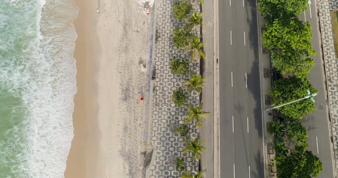 Flying directly above palms on Ipanema Beach iconic sidewalk, Rio de Janeiro, Brazil