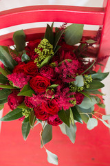 Wedding. Lush bridal Bouquet of red roses and a lot of greenery
