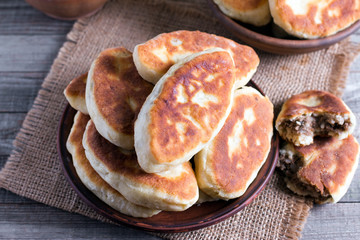 Fried patties with the meat in the plate on wooden table