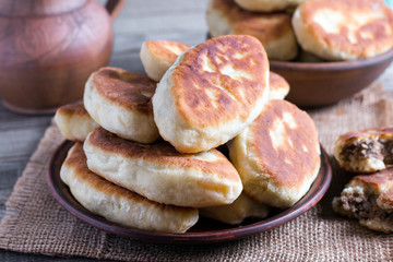 Fried patties with the meat in the plate on wooden table