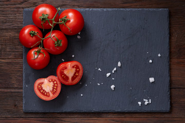 Composition with fresh tomatoes on wooden background, close-up, selective focus.
