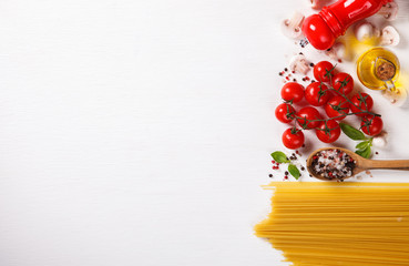 Pasta Spaghetti with ingredients for cooking pasta on a white background, top view. Copy space for Text. selective focus.