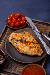 Closeup grilled fillet chicken and marinated tomatoes