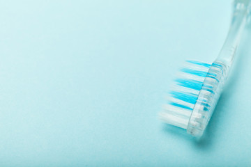 Close up, toothbrushes on empty blue background. Copy space for text.