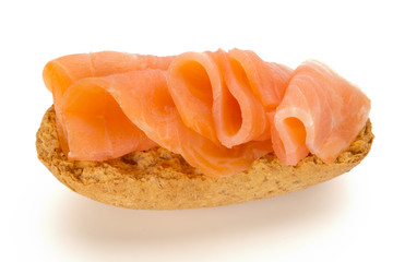Bread with fresh salmon fillet isolated on white background, top view.