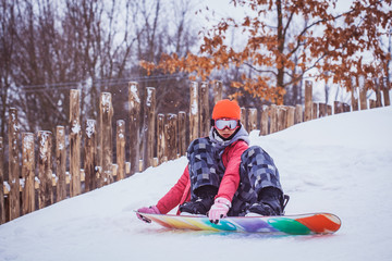 Fototapeta na wymiar woman snowboarder skiing on the snow-covered slope