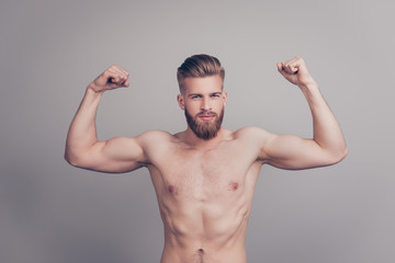 Portrait of brutal sporty athletic sportive fit slender muscular handsome serious flirty strong powerful coquettish macho demonstrating big biceps isolated on gray background