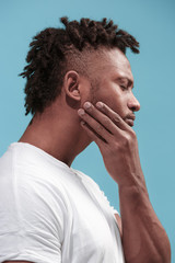 Young Afro-American man is having toothache.