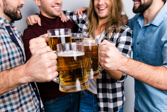 Network socializing bonding connection triumph holiday concept. Cropped close up photo of excited delightful cheerful guys clinking pints of beer, casual checkered outfit, fan of championship football