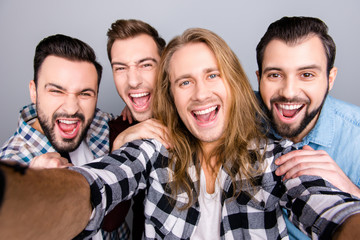 Diversity virility masculinity spend funtime concept. Close up photo of four excited enthusiastic astonished amazed friendly guys taking selfie checkered jeans shirt isolated on gray background