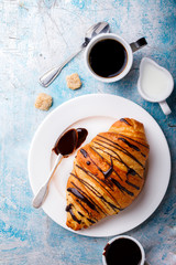   Breakfast Continental  with Fresh  Croissants on a blue Background Coffee  and milk Delicious Baking with  with Chocolate Topping  Top View Copy space for Text