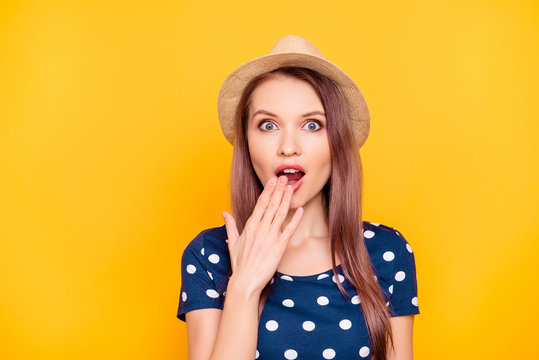 Everywhere sales! Portrait of charming, pretty, nice, impressed, surprised girl in polka-dot t-shirt closing her wide open mouth with palm, isolated on yellow background, looking at camera