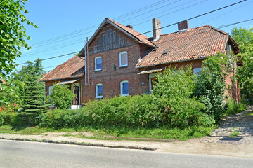 Fototapeta na wymiar Red brick house of pre-war construction. Settlement Amber, Kaliningrad region