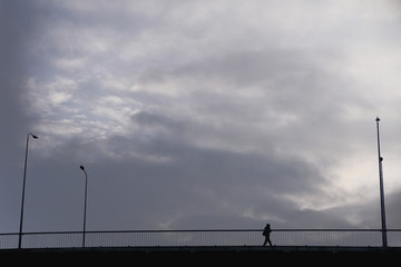 Silhouette person on the bridge with street lanterns