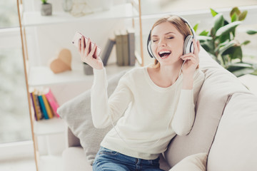 Happiness enjoy careless casual hobby people person talent gift concept. Crazy beautiful restless active inspired cute pretty woman wearing jeans white sweater singing songs listening to tunes tracks