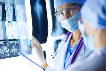 Two female women medical doctors looking at x-rays in a hospital.