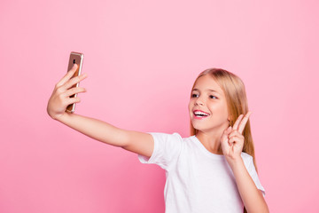 Model people education freetime hobby selfie shots pre teen dream concept. Portrait of cute sweet lovely dreamy careless excited cheerful girl taking selfie on telephone isolated on pink background
