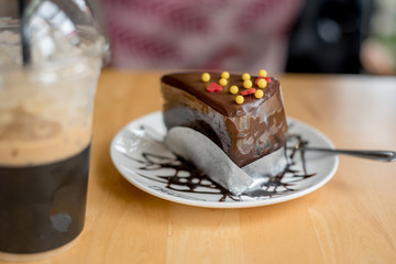 ice coffee take away and cake on wooden background