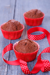 Red muffins on a wooden table