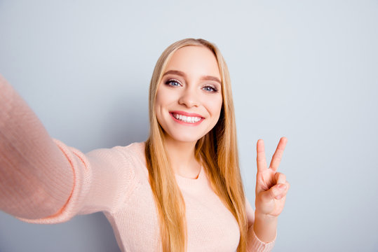 Connection casual roaming glamour style toothy people funtime person concept. Close up portrait of cute cheerful excited sweet lovely joyful girl taking selfie with v-sign isolated on gray background