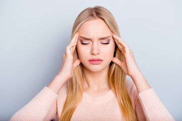 Fototapeta premium Education sick unwell university lifestyle spasm people person concept. Close up portrait of sad upset unhappy exhausted frustrated troubled woman touching temples isolated on gray background