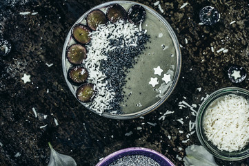 Healthy smoothie bowl with grape slices coconut flakes and poppy seeds