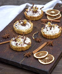 sweet cakes with white cream and chocolate powder
