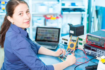 Young woman in electronics repair service center