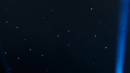 Spotlights at the disco. Constructions of the stage at the concert. Beautiful and colorful lights of the stage at the concert. Stage lights and smoke.