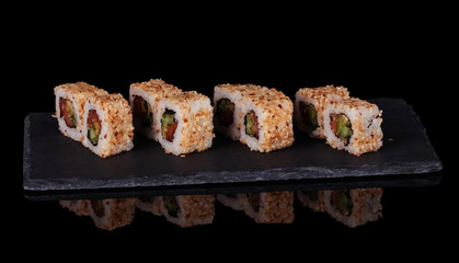 Traditional Asian platter of sushi on special stand, isolated on black