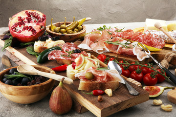 Italian antipasti wine snacks set. Cheese variety, Mediterranean olives, pickles, Prosciutto di...
