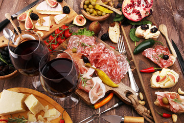Italian antipasti wine snacks set. Cheese variety, Mediterranean olives, pickles, Prosciutto di Parma and salami