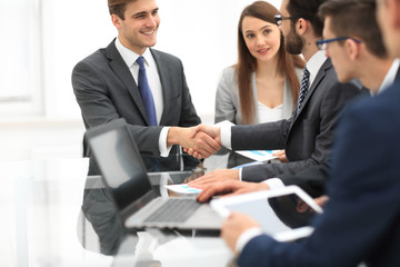 Business colleagues sitting at a table during a meeting with two