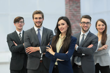 Attractive young business owner in office, folded hands in fron