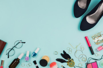Beautiful fashion flatlay arrangement with various fashion accessories: glasses, cosmetics, jewelry, rings, shoes etc. Mint background. Concept of preparation. Copyspace