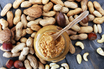 Creamy peanut butter on wood table. Selective focus.