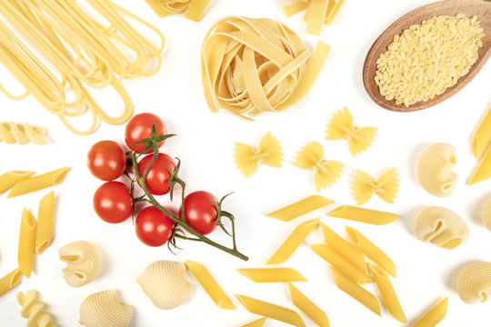 Overhead photo of different types of pasta on white